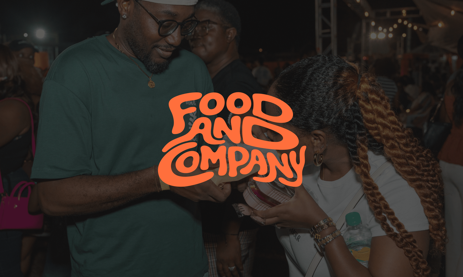 Guests holding a Food and Company sign