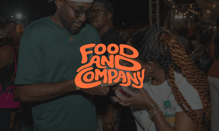 Guests holding a Food and Company sign