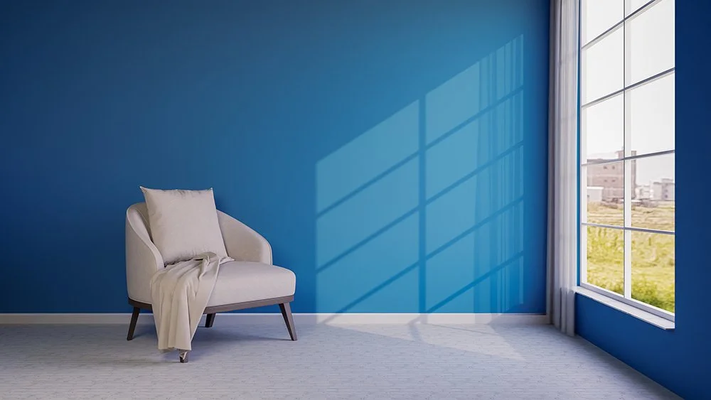 vecteezy_a-chair-and-a-window-in-a-room-with-blue-walls_67241060_WEB.jpg