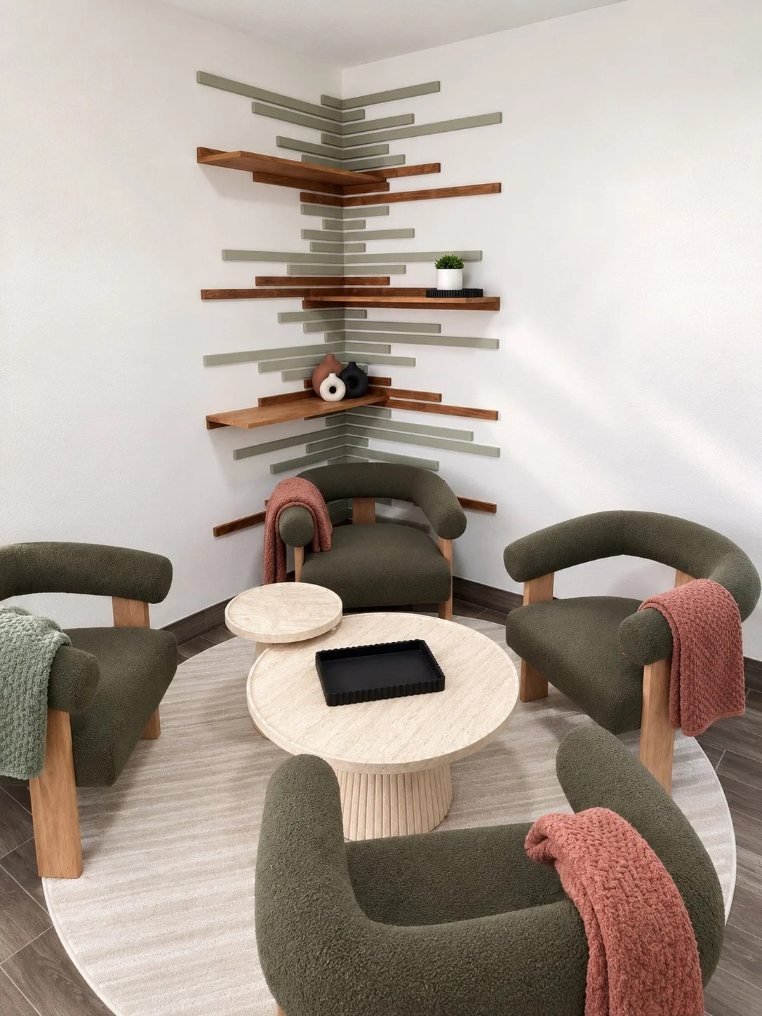 Custom corner shelves with wood and sage green wall details.