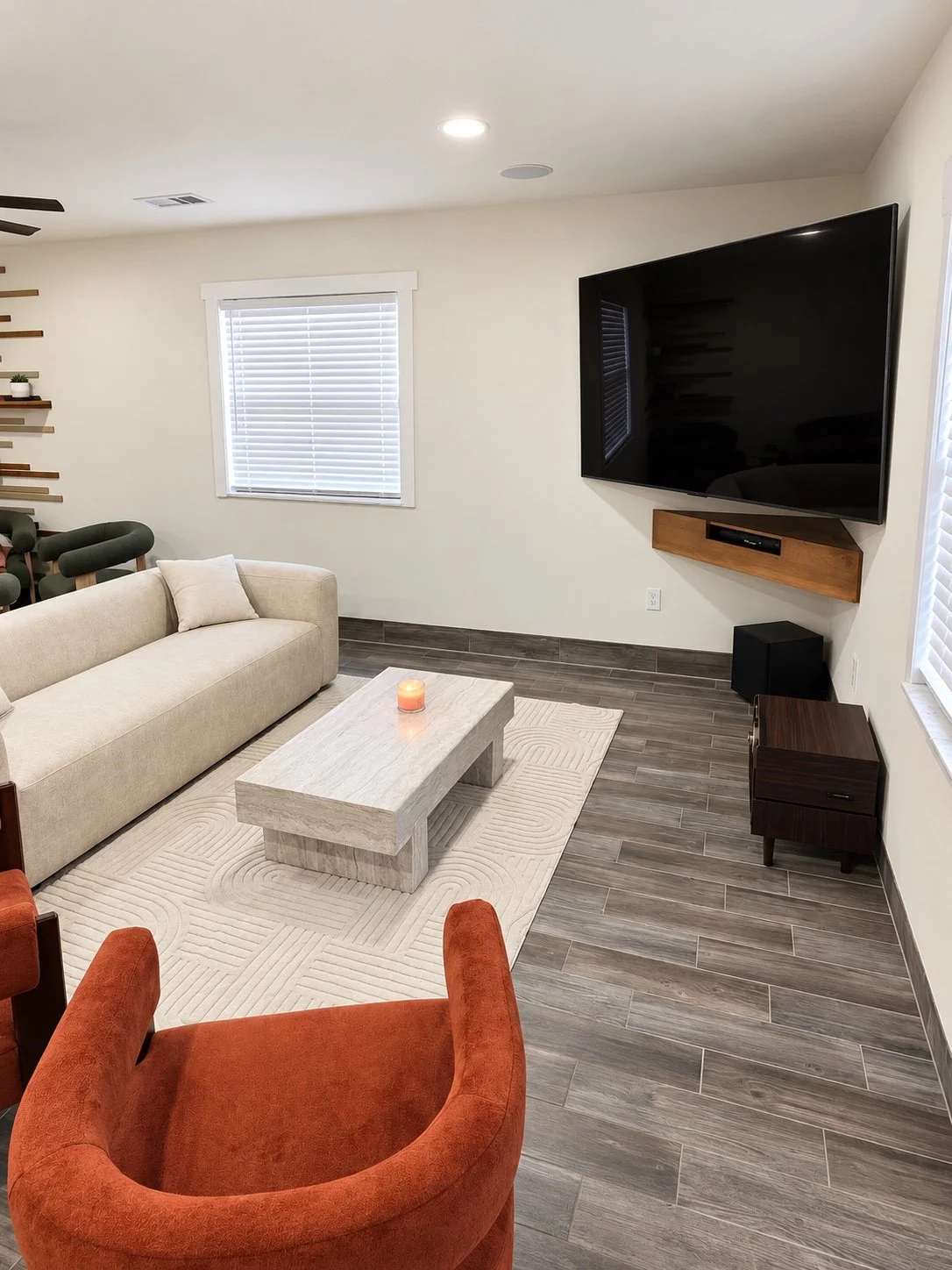 Living room with a floating wood media shelf and coordinated seating.