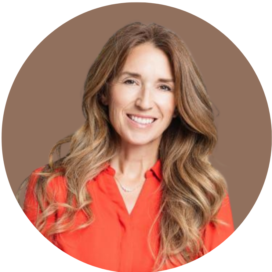 A woman with long wavy light brown hair, smiling, wearing a red blouse, in front of a neutral background.