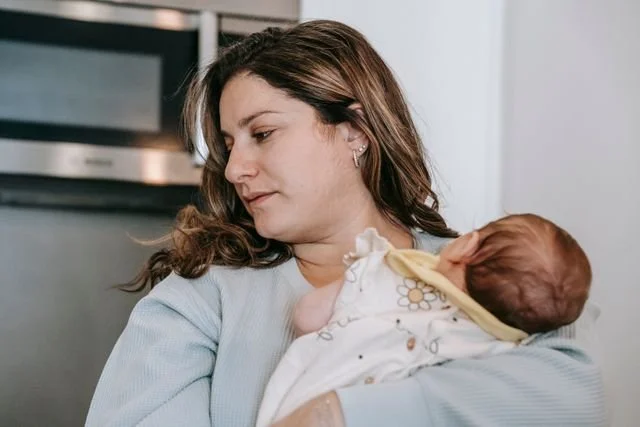 Postpartum mother holding her newborn