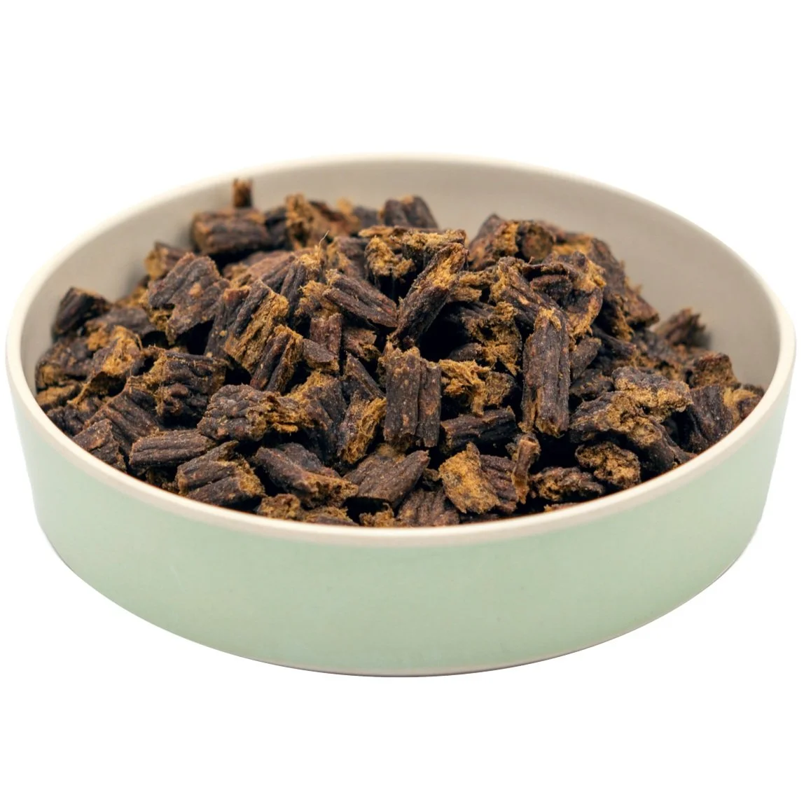 A white bowl filled with dried black licorice root pieces.