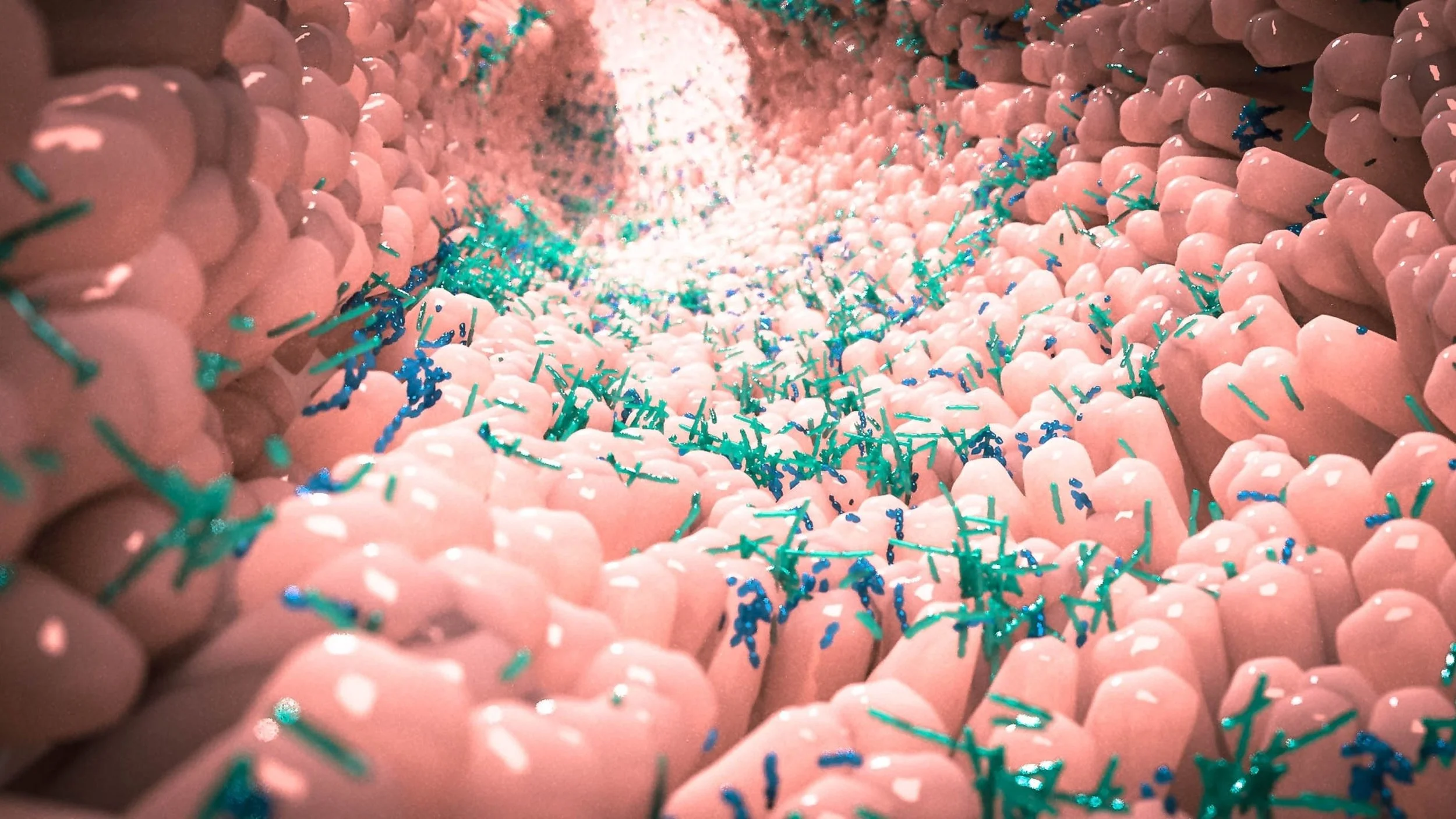 Close-up of pink foam with blue and green sprinkles, creating a textured pattern.