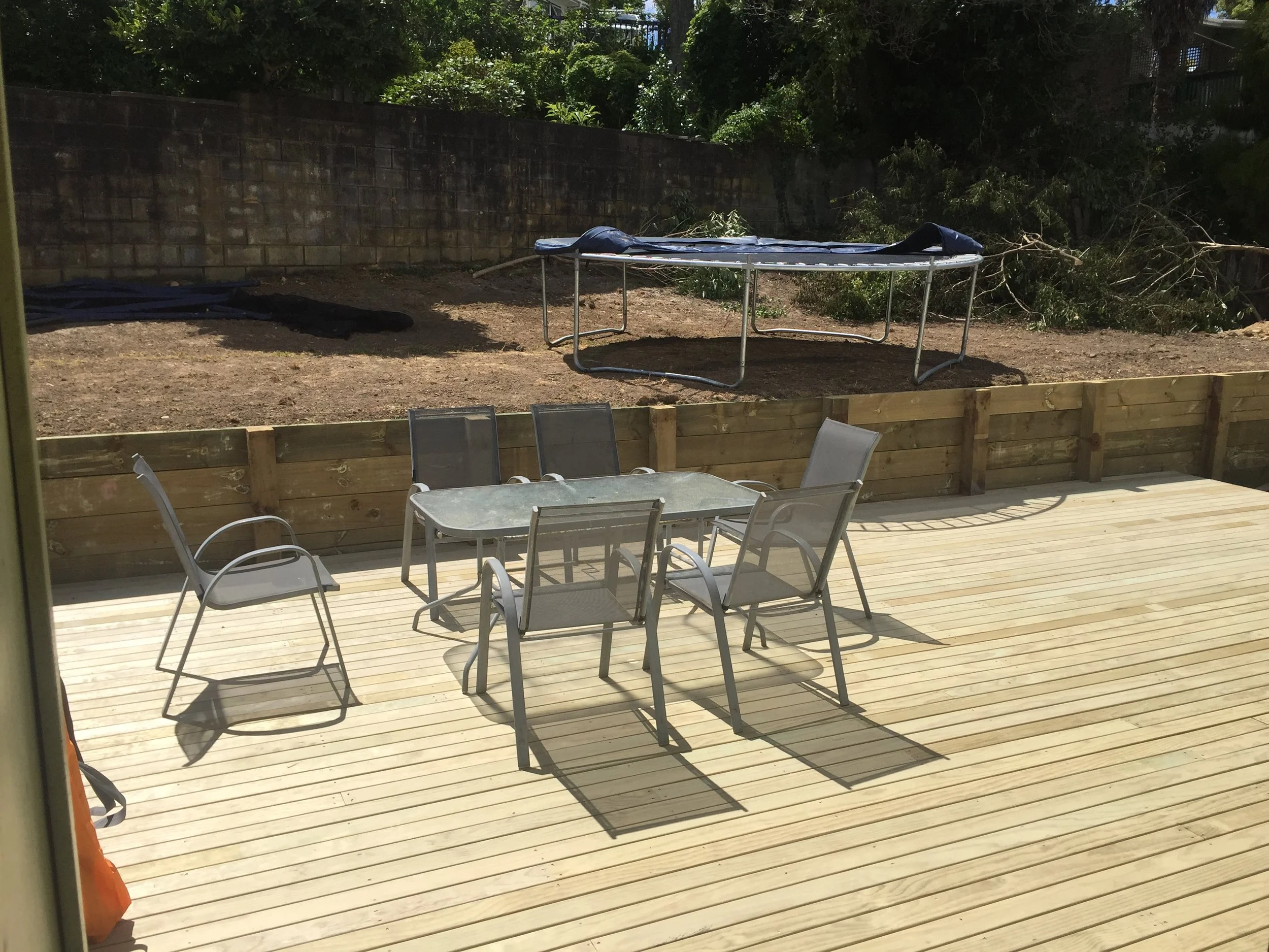 Back yard leveled , retaining wall and deck built