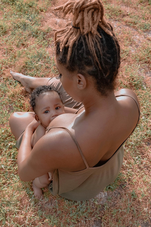 Woman cradling a baby to her chest to feed
