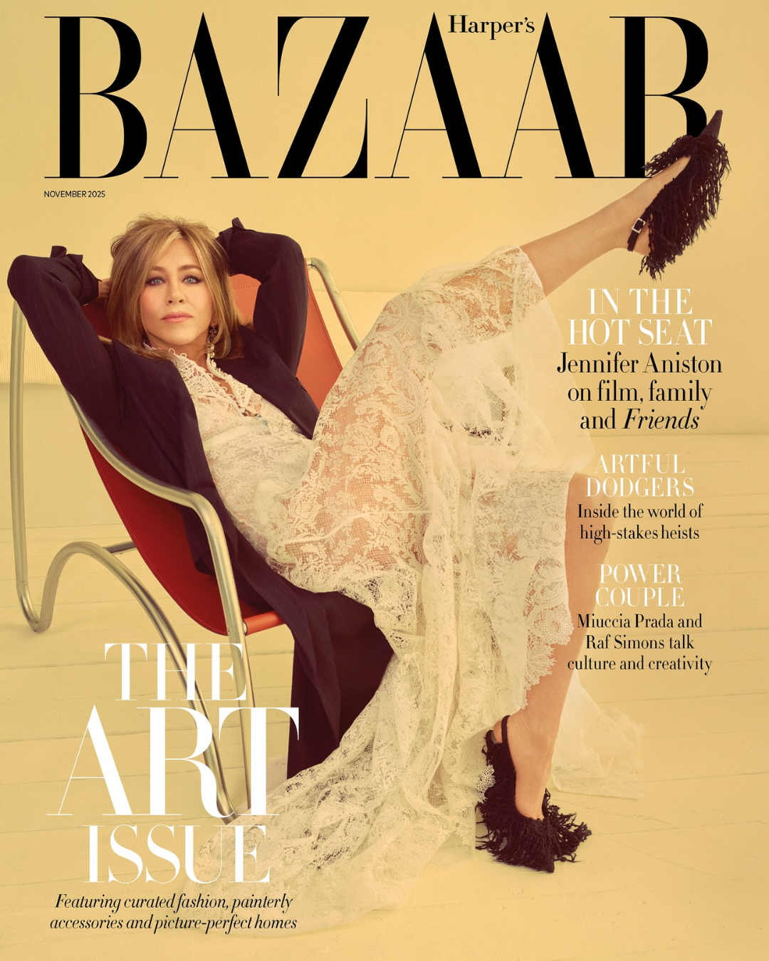 Cover of Harper's Bazaar magazine, November 2025 issue, featuring Jennifer Aniston in a relaxed pose with a lace dress and black heels, sitting in a modern chair with a yellow background.