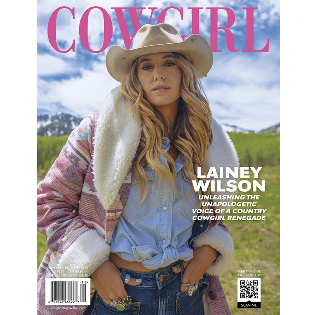 Cover of Cowgirl magazine featuring Lainey Wilson outdoors in a countryside setting wearing a cowboy hat, denim shirt, and colorful jacket.