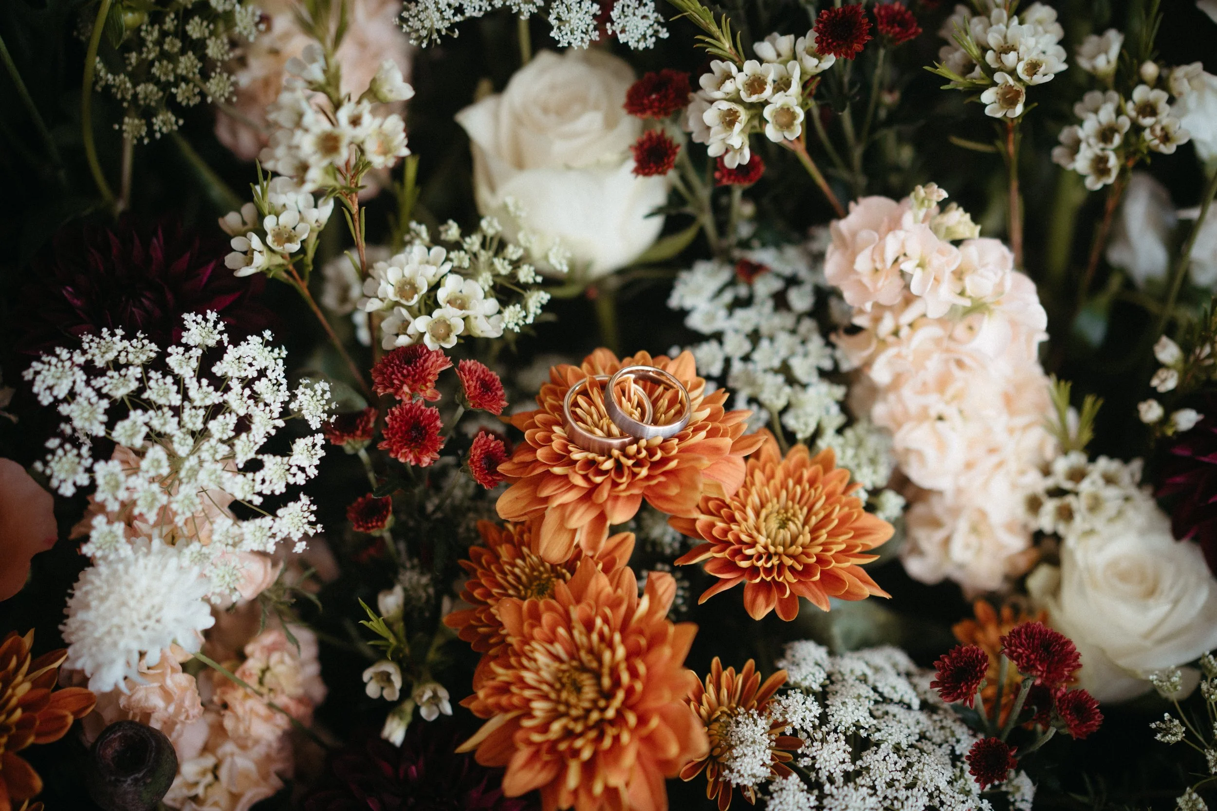 Wedding rings layed on a bed of flowers