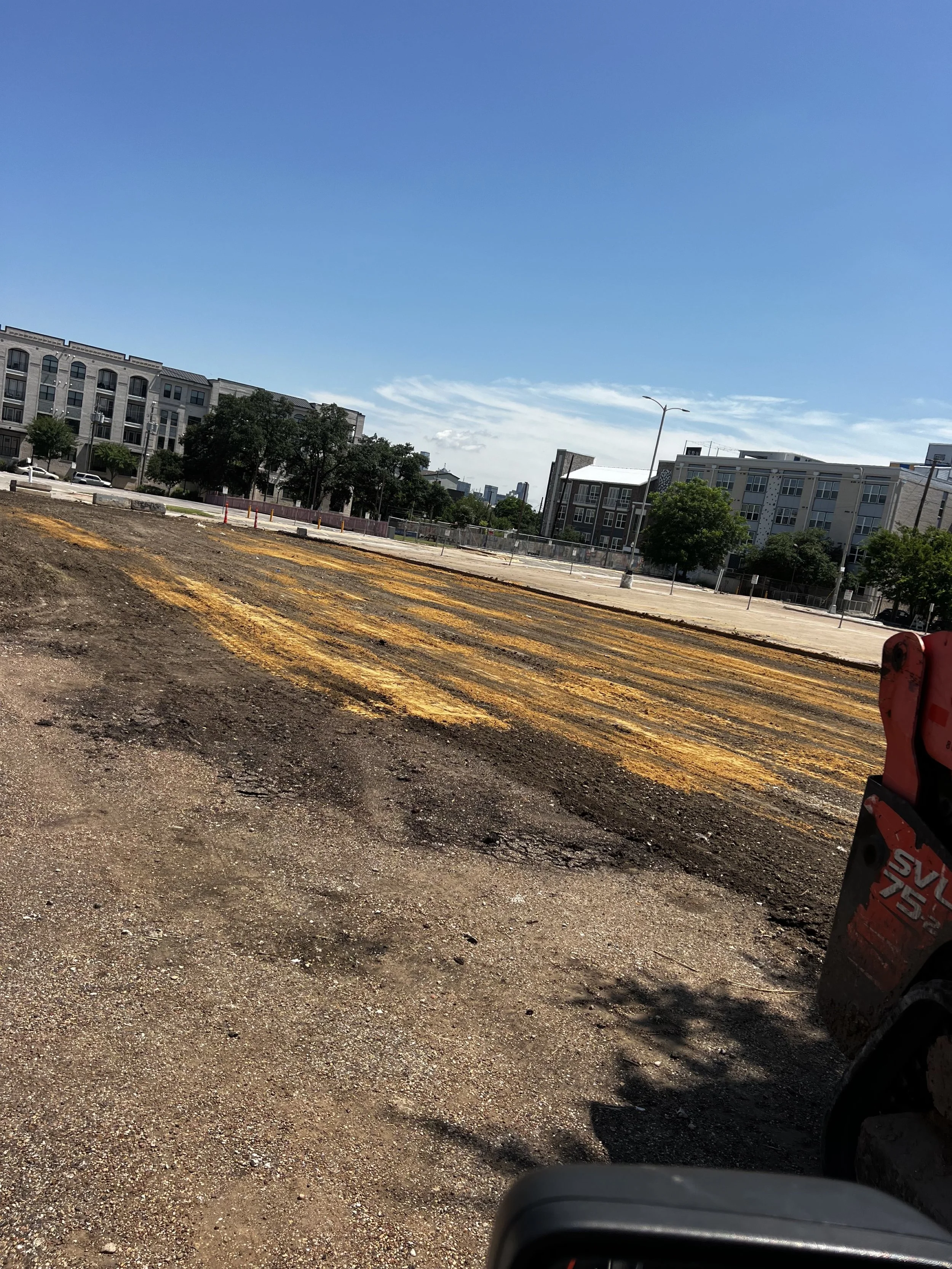 Prepared construction area with yellow markings across the ground.