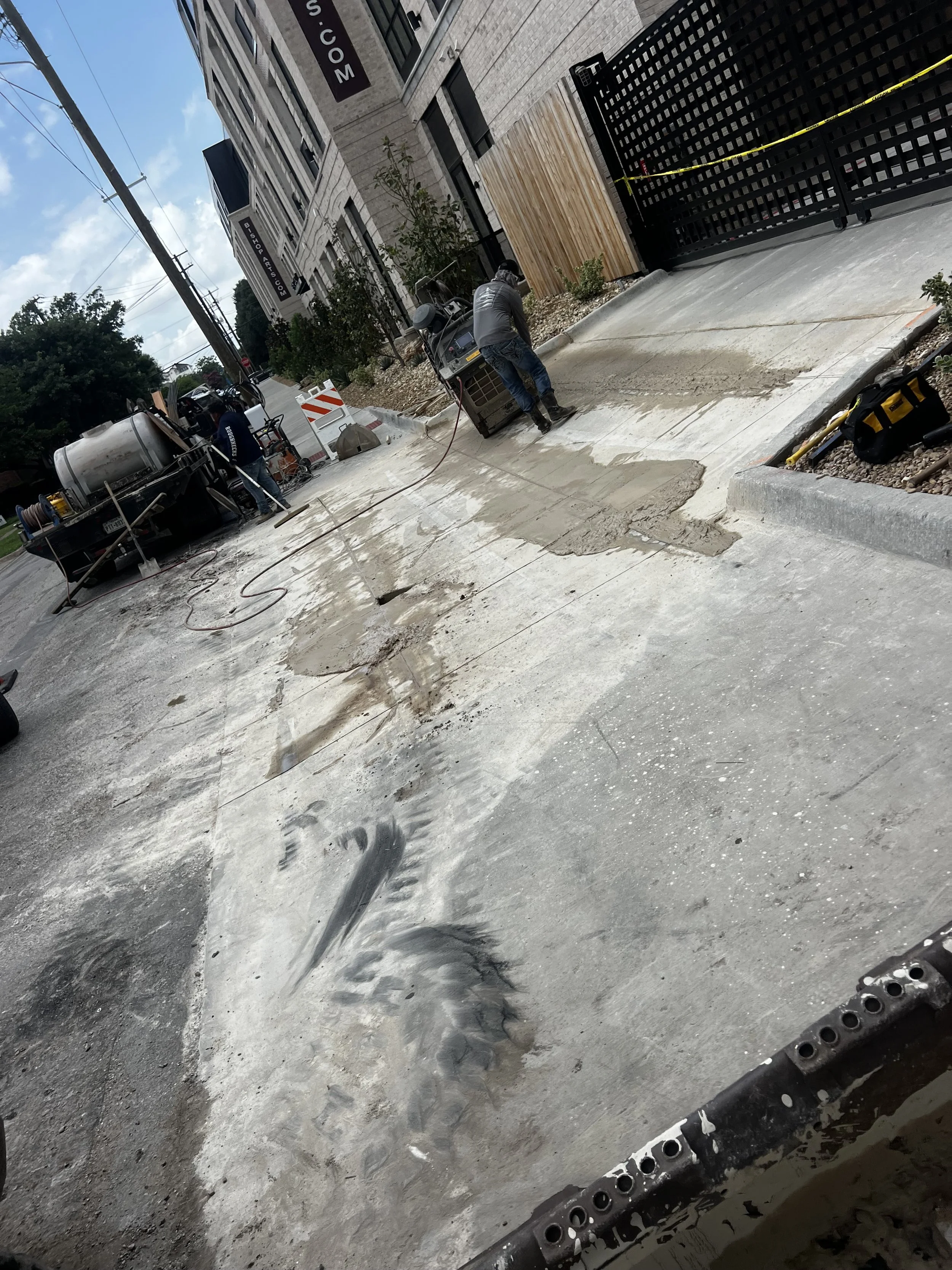 Broken concrete and exposed base material during sidewalk removal.