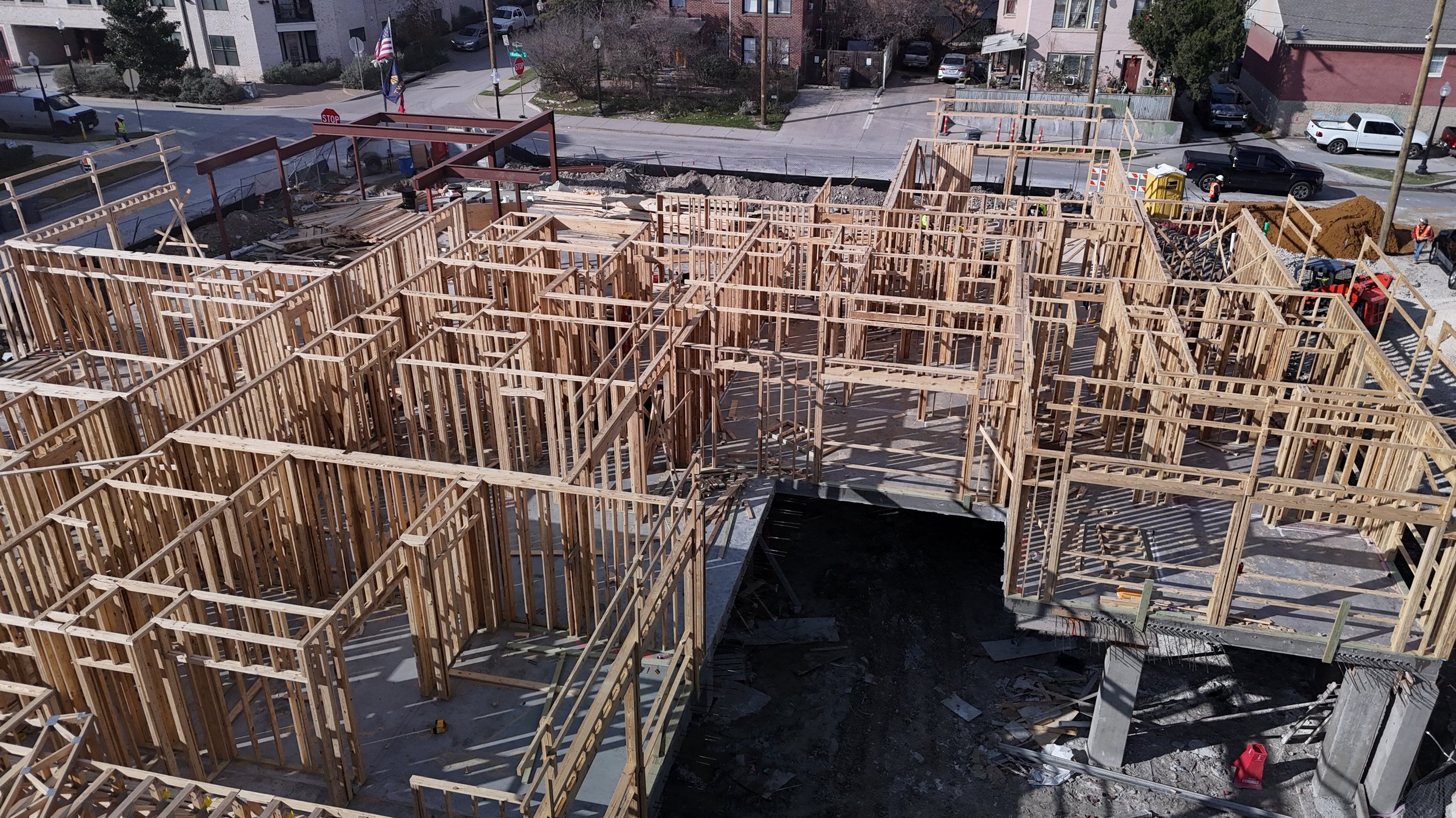 Interior wood-framed walls forming rooms and corridors on a building under construction.