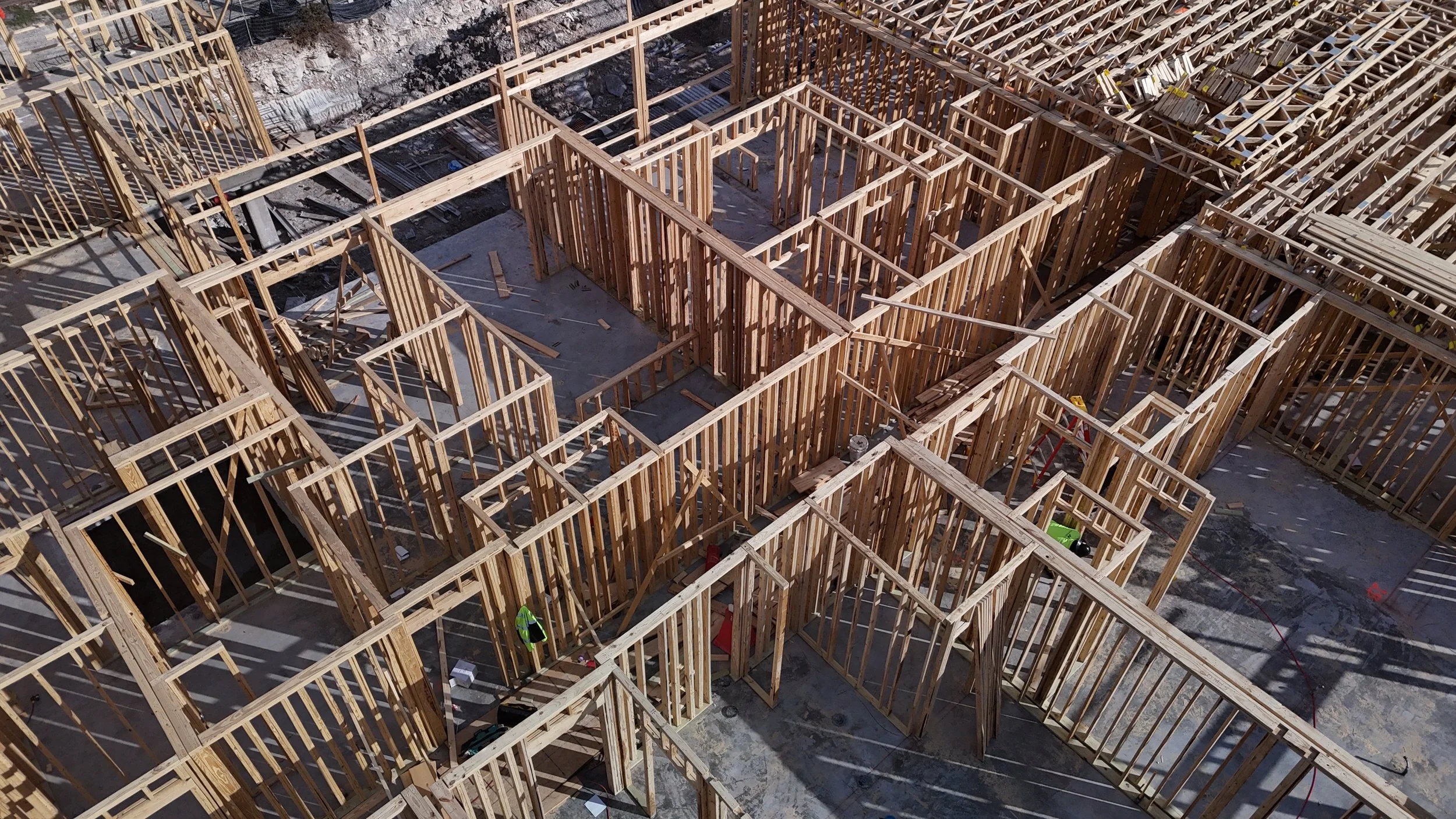 Overhead view of wood wall framing arranged around floor openings.