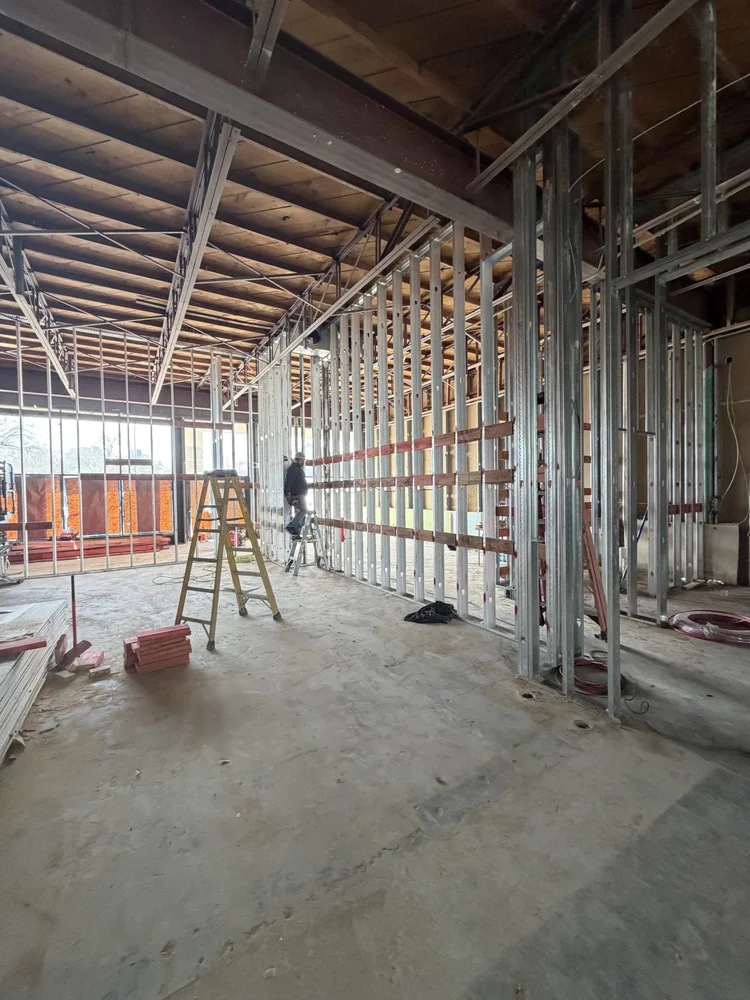 Exposed metal framing and building services during the Jungle Pilates interior renovation.