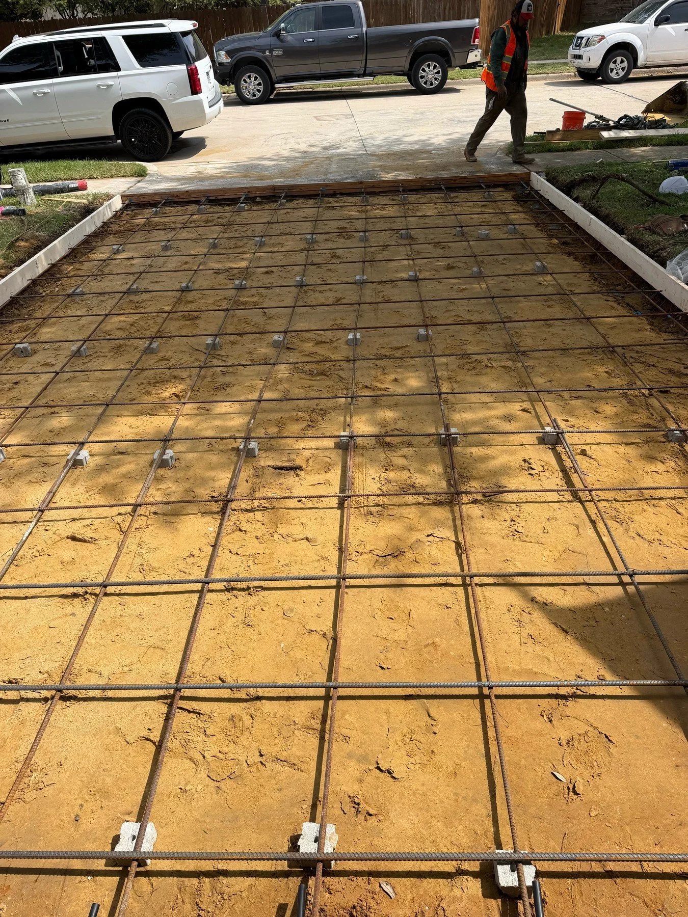 Steel reinforcement and perimeter forms prepared for a residential driveway pour.