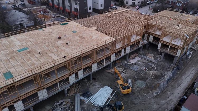 Bishop Modern building under construction, with timber framing above the concrete structure.