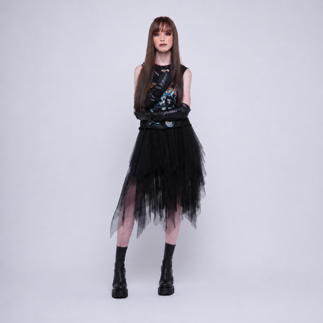 Woman wearing a black performance outfit against a light background