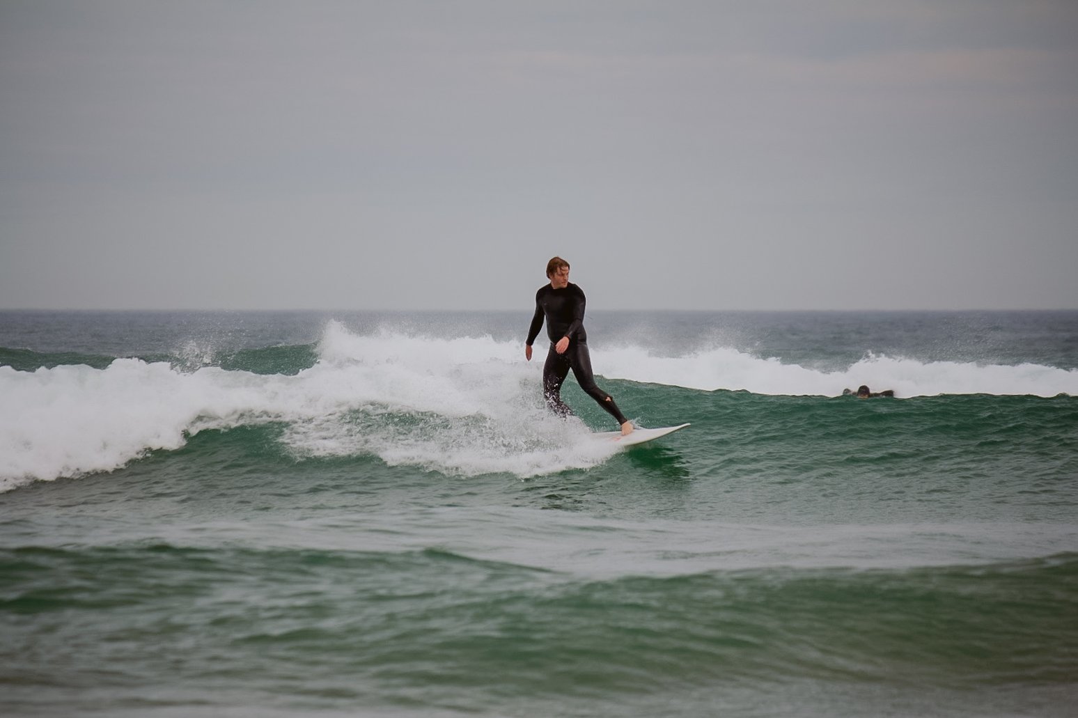 Participant surfing during a SeaEarth Adventures corporate adventure program