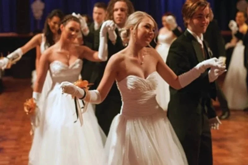 Couples in formal attire dancing at a wedding reception