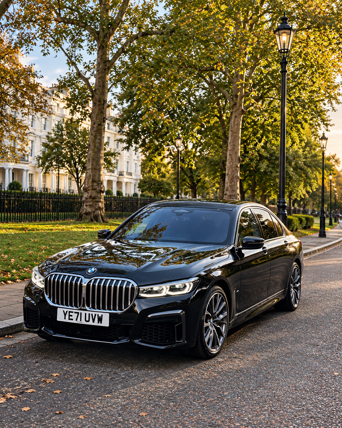 Black BMW 7 Series parked on a tree-lined street in London.