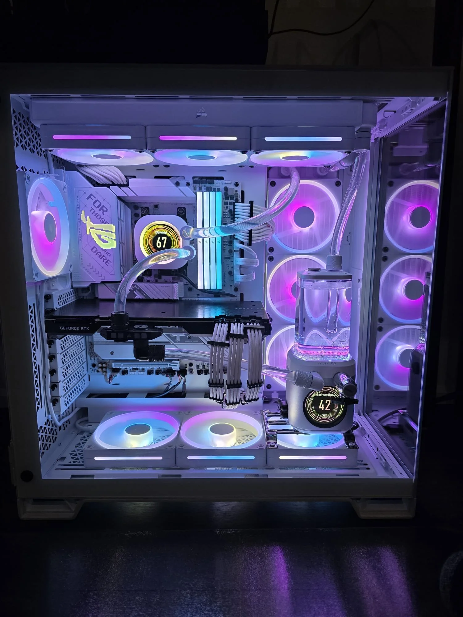 A custom-built gaming computer with white and RGB lighting, water cooling system, multiple case fans, and an NVIDIA GeForce RTX graphics card inside a white case.