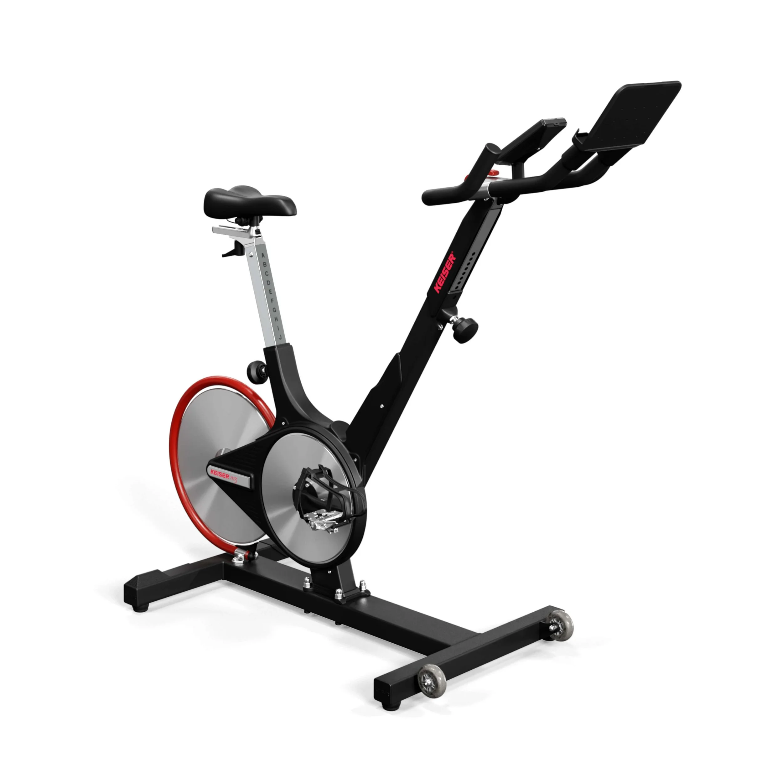 A stationary exercise bike with a black frame, large circular silver flywheel at the front, a padded seat, and an electronic display screen.