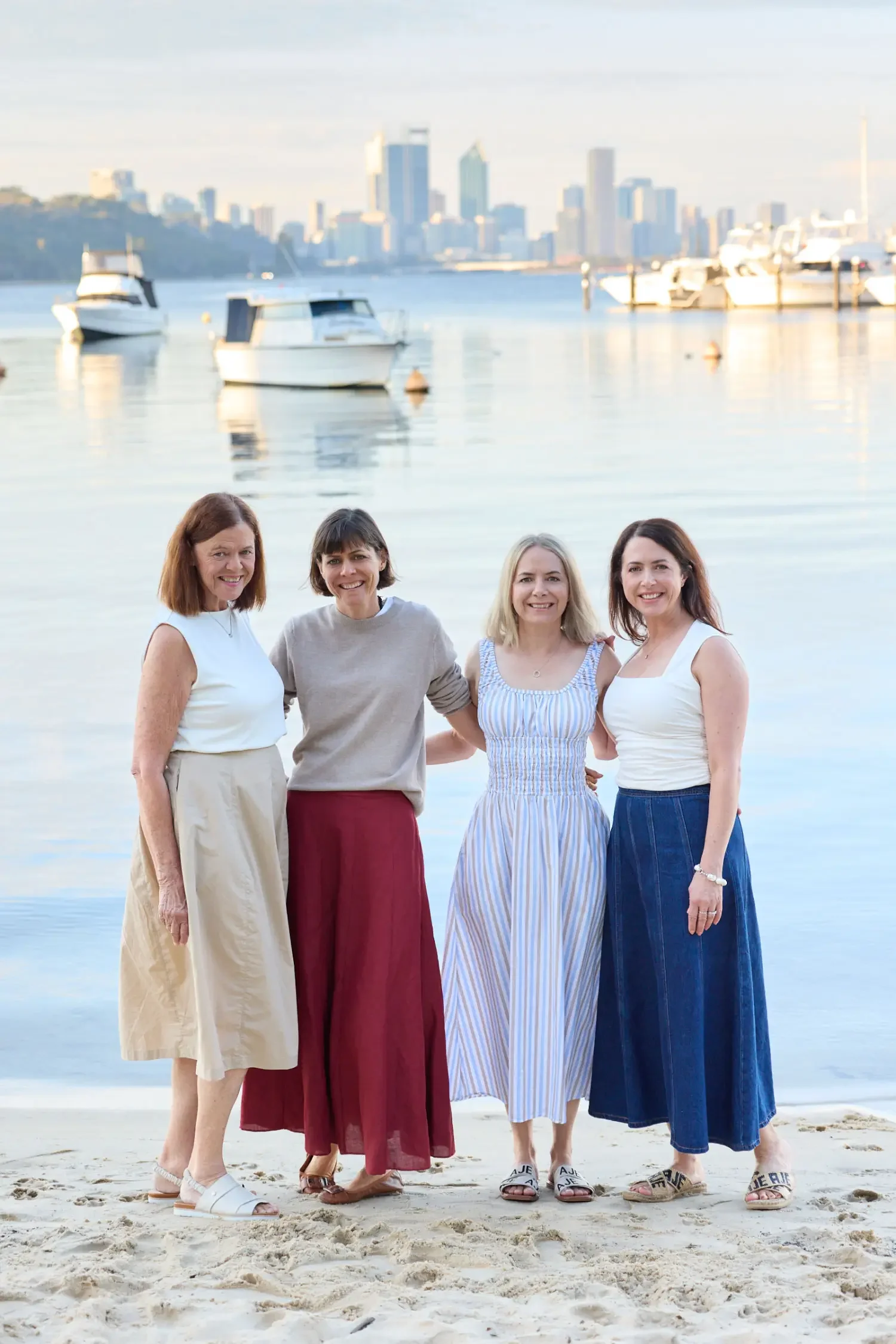 Extended-family-in-front-of-swan-river-with-Perth-skyline.webp