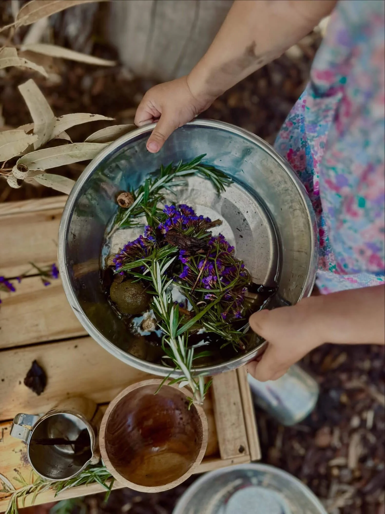 We-are-nature-kids-hand-holding-metal-bowl-with-flowers-twigs.jpg