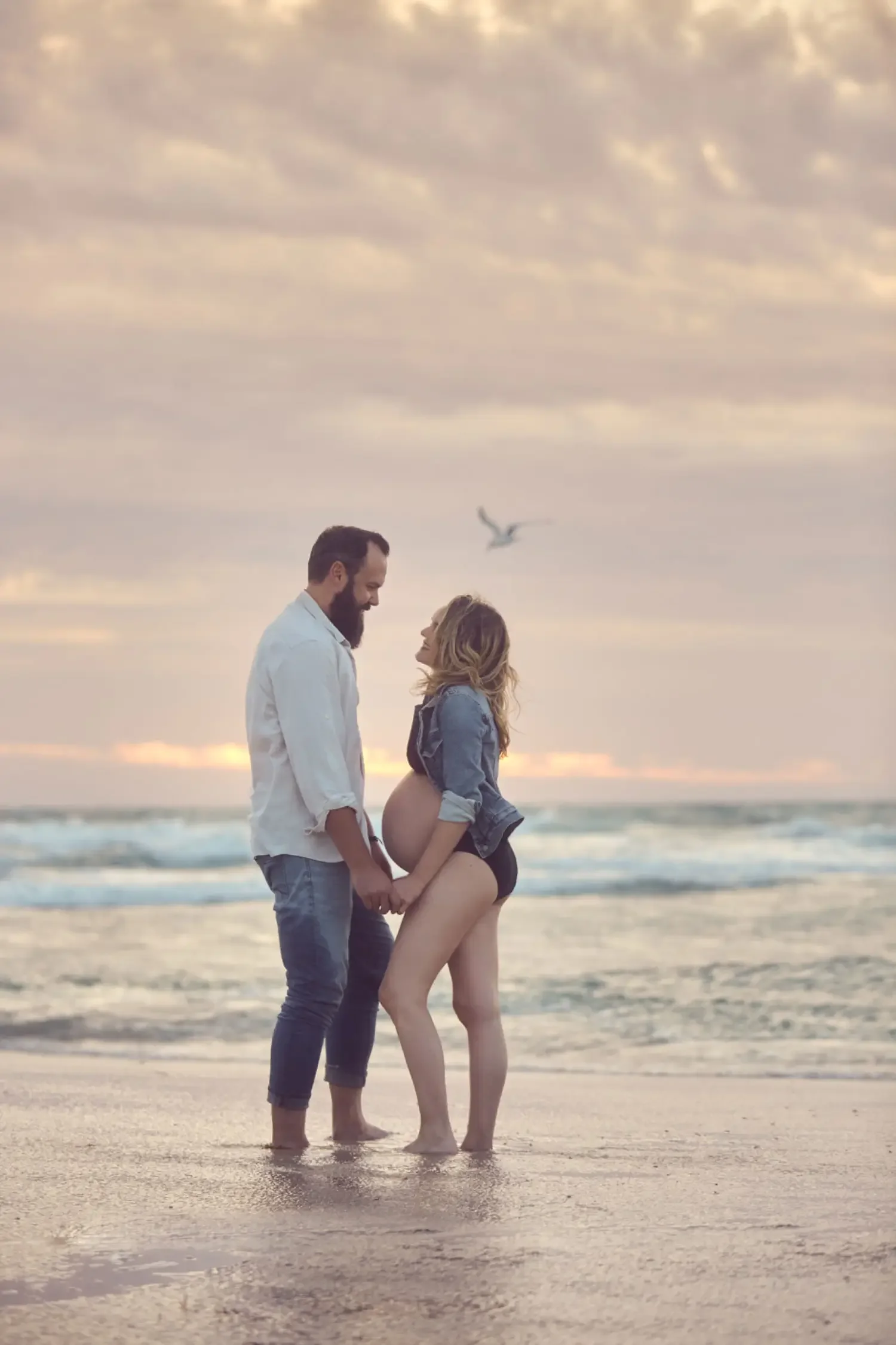 Couple-Pregnant-Woman-on-the-Beach.webp