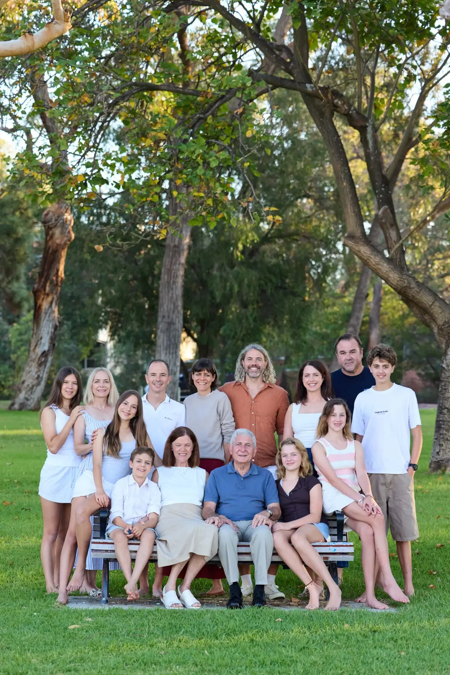 Extended-family-sitting-under-tree-at-Matilda-Bay.webp