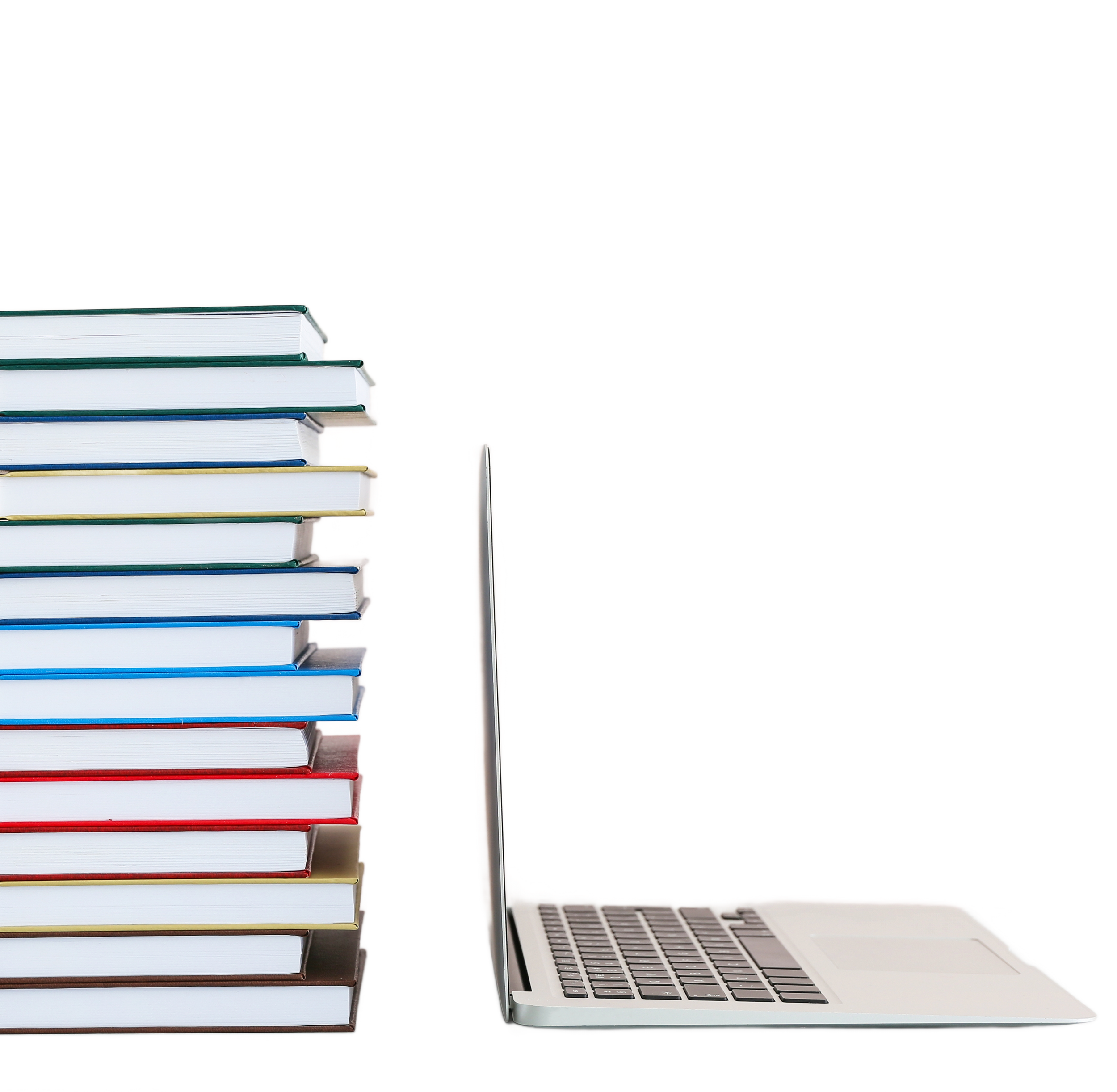 Stack of neat colorful books beside an open laptop on a black background