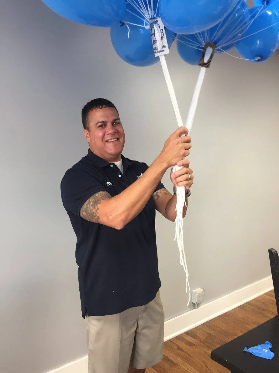 Bill Butler holding balloons