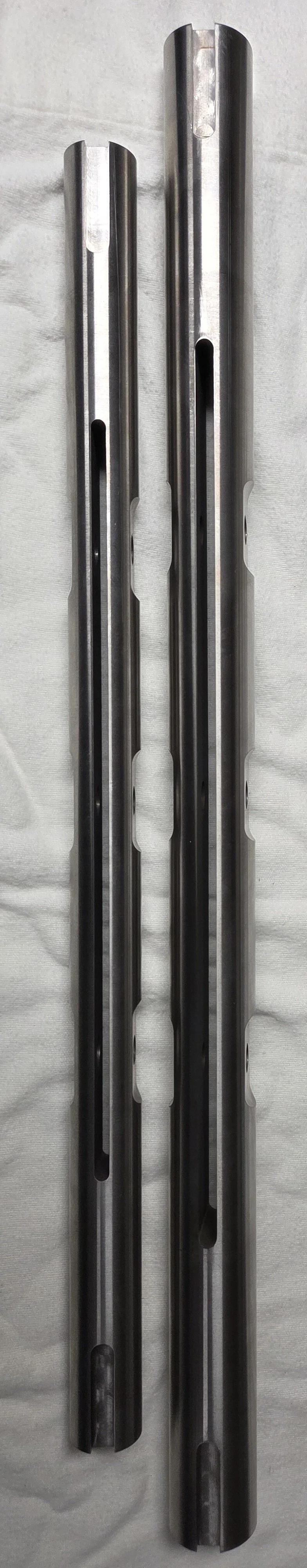 Custom bearing shafts with long slots and keyways machined from stainless steel.