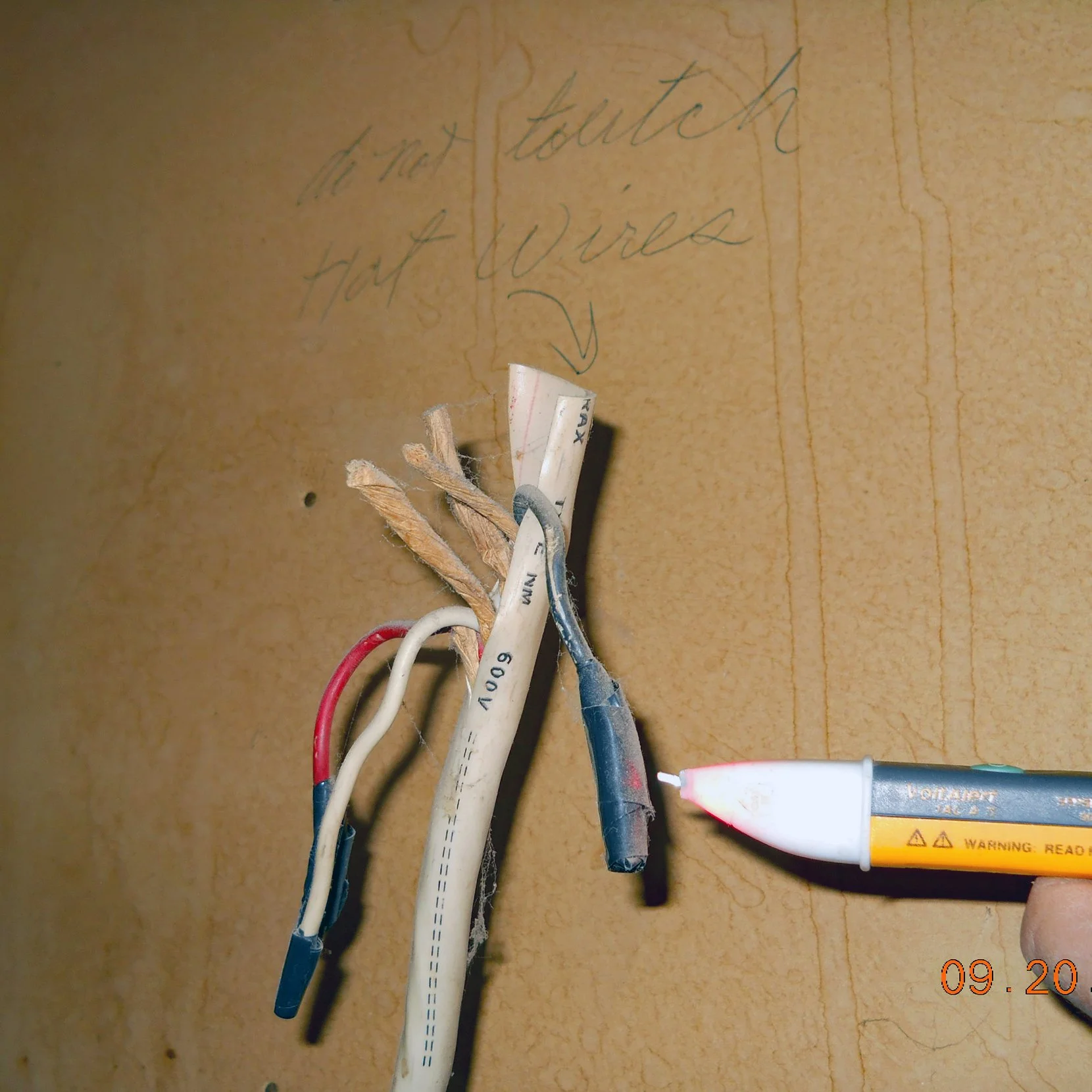 Non-terminated 220-volt electrical wiring in a closet registering hot or live or active found during a home inspection.