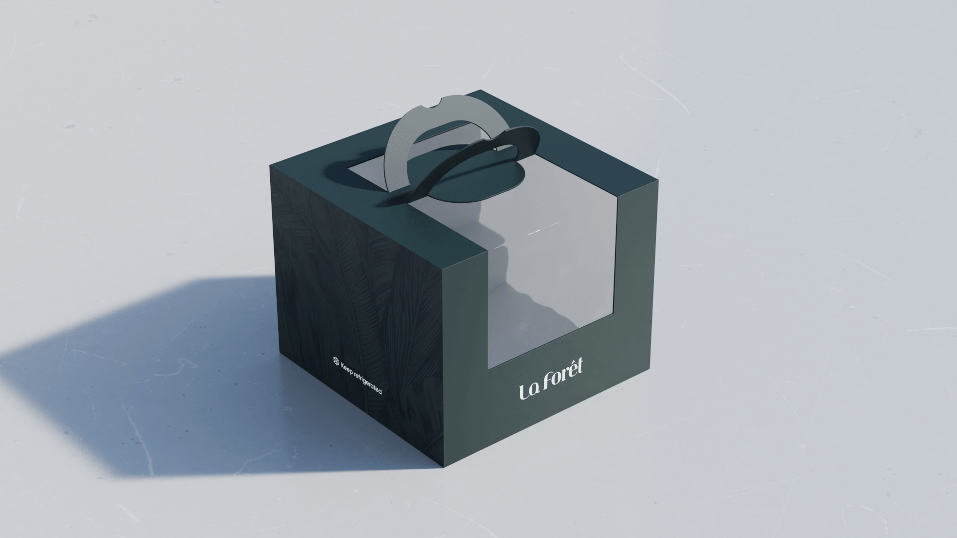 A boxed product named 'La Forêt' with a black and white design featuring a tree silhouette, a black handle on top, and a label indicating to keep refrigerated, placed on a white surface with a shadow.