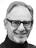 A smiling man with gray hair, glasses, and a beard, wearing a black shirt.