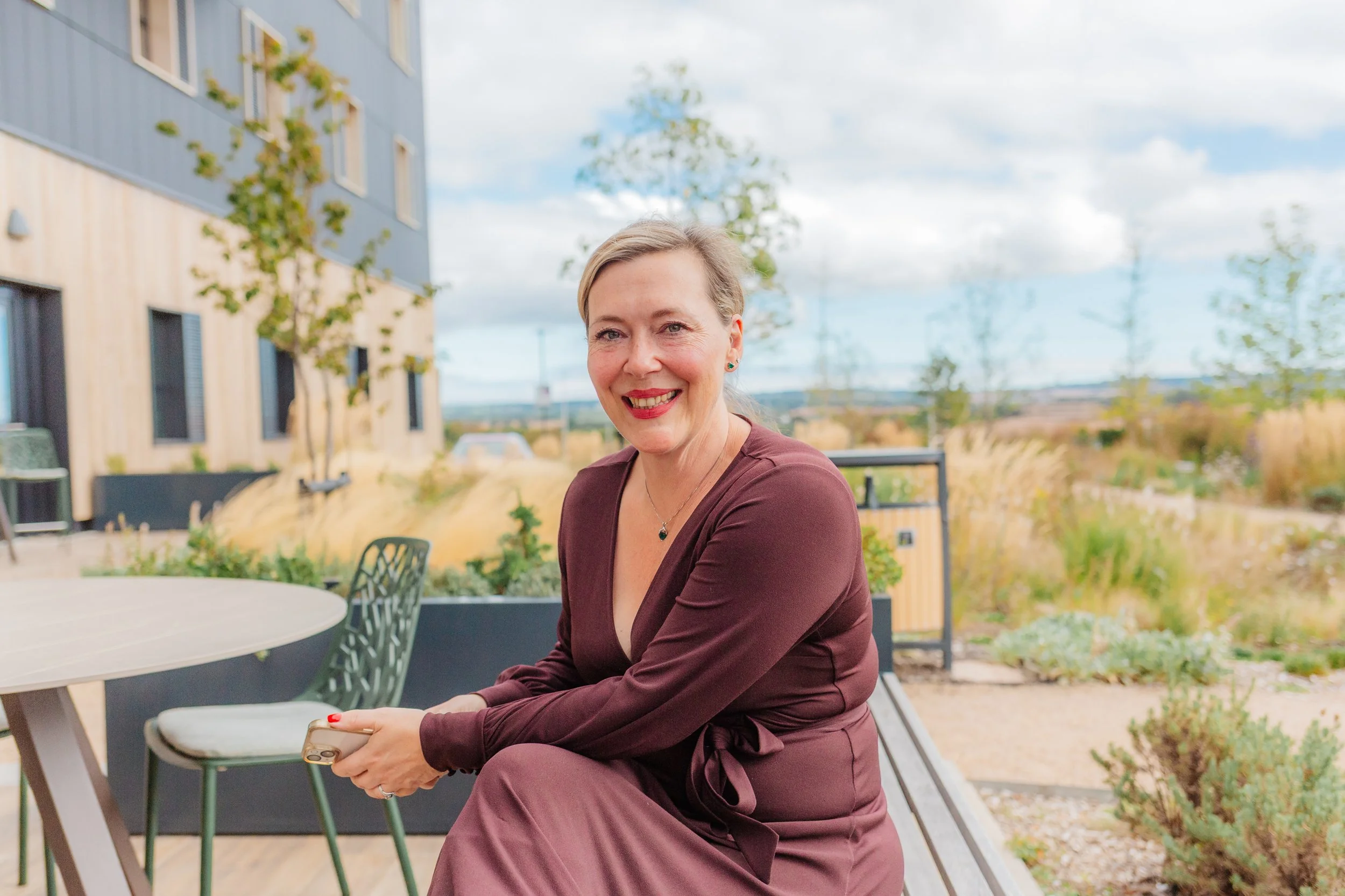 Sarah Knight, Mental Health Instructor at Sekular, smiling and seated outdoors