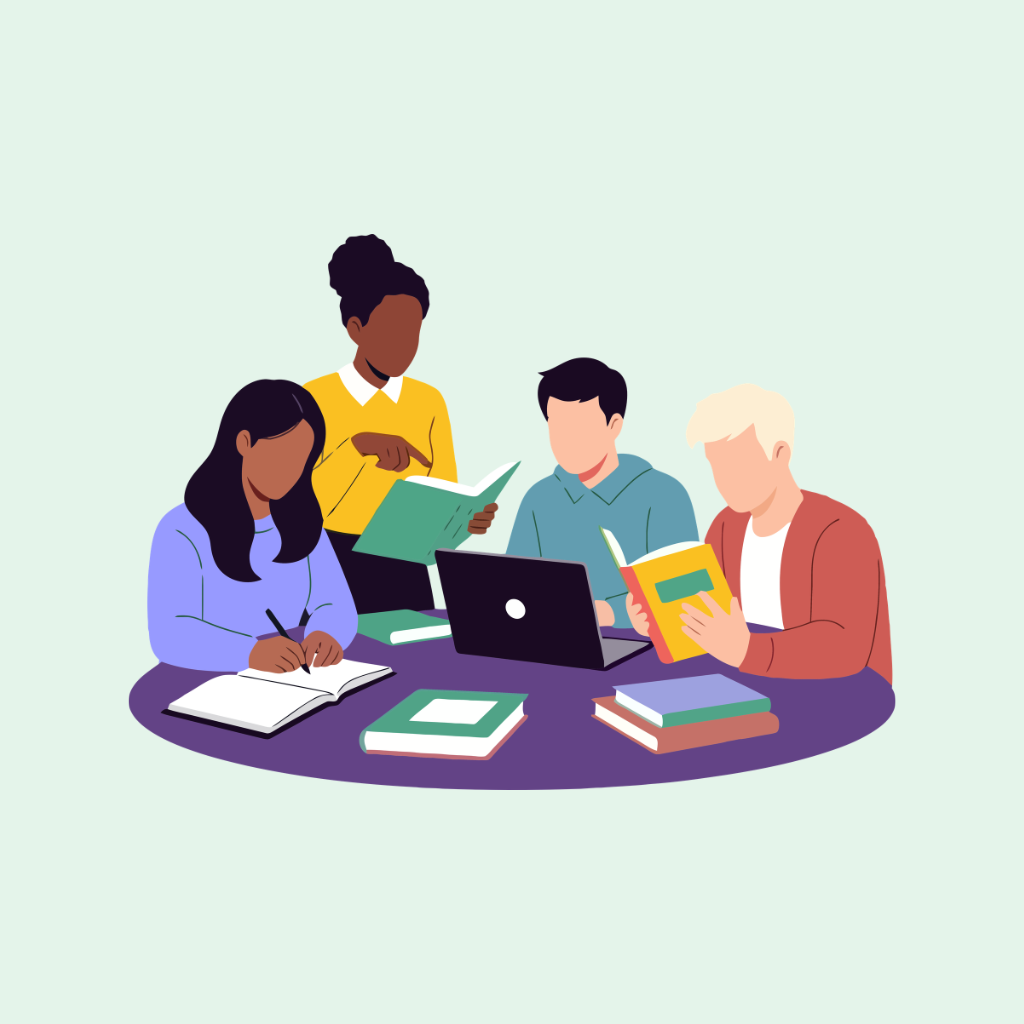 A group of four diverse students studying together with books and a laptop at a round table.
