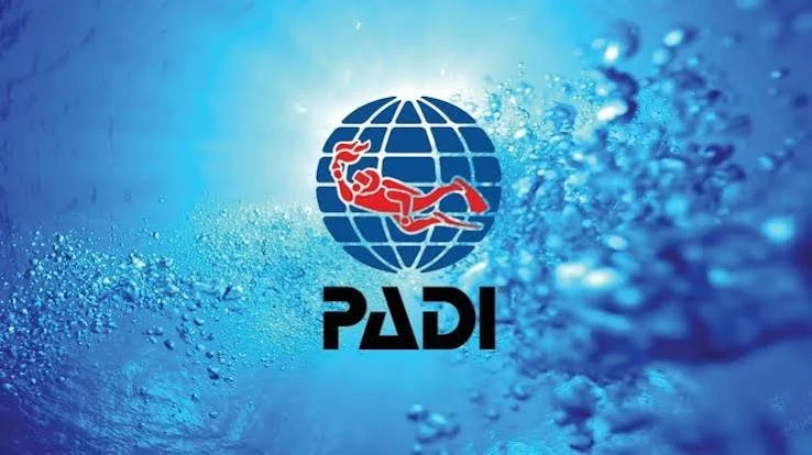 PADI logo with a red scuba diver over a globe background surrounded by bubbles.