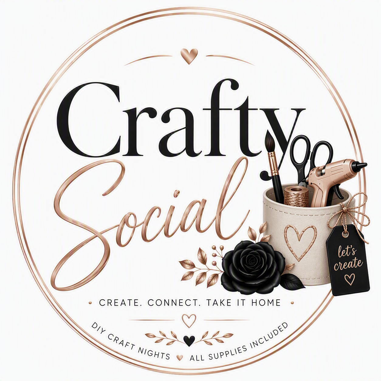 A circular logo for "Crafty Social" with a white background, featuring black and rose gold cursive and serif fonts. The logo includes a small heart, a black rose with leaves, and a container holding craft tools like scissors, glue gun, and a paintbrush. There is a black tag with "let's create" attached to the container. The tagline reads "Create. Connect. Take it home" and additional text says "DIY craft nights" and "All supplies included".