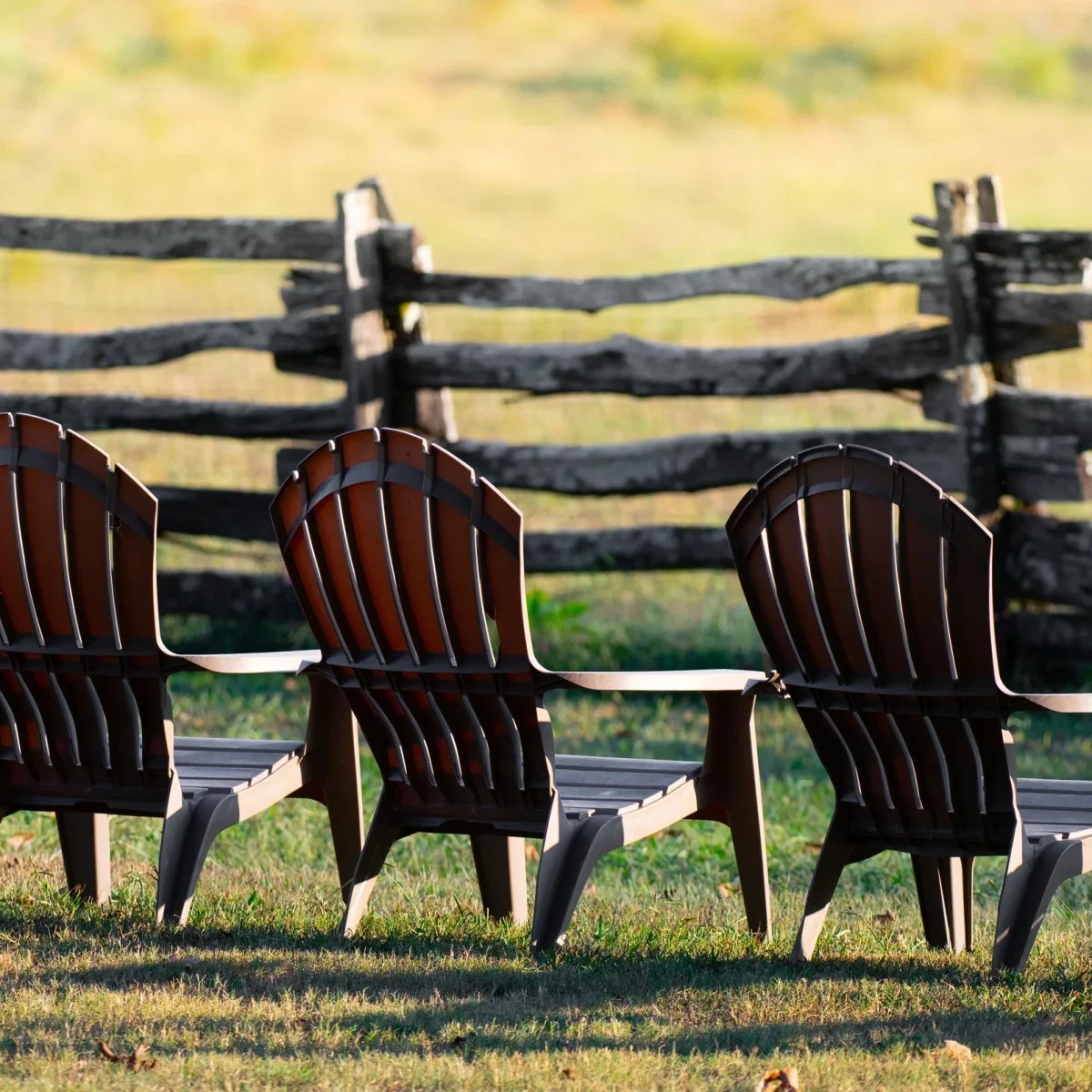 Adirondack chairs set beside the pasture at Seventy-Four Ranch