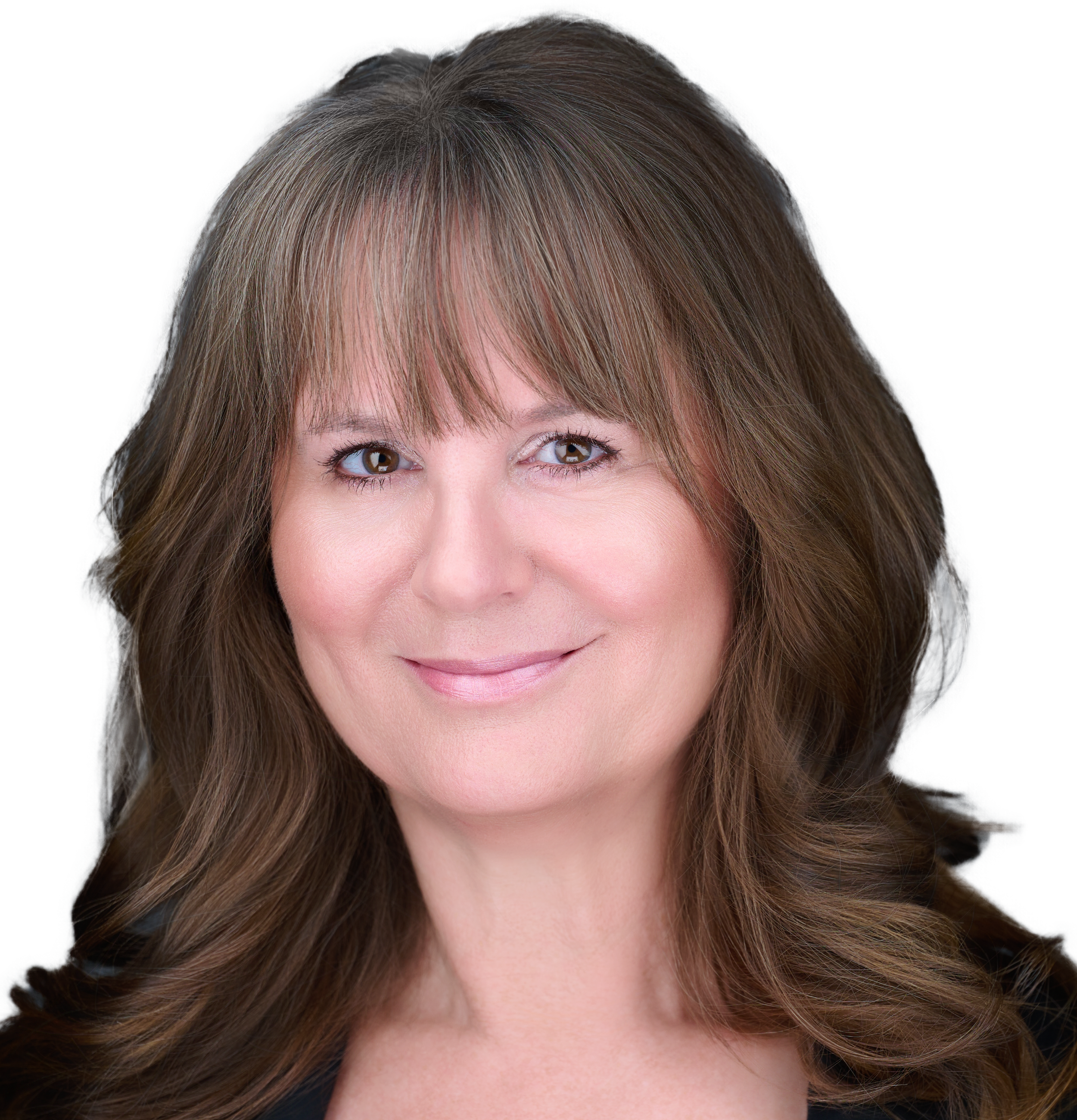 Close-up of a smiling woman with brown hair and bangs, showing her forehead and eyes.