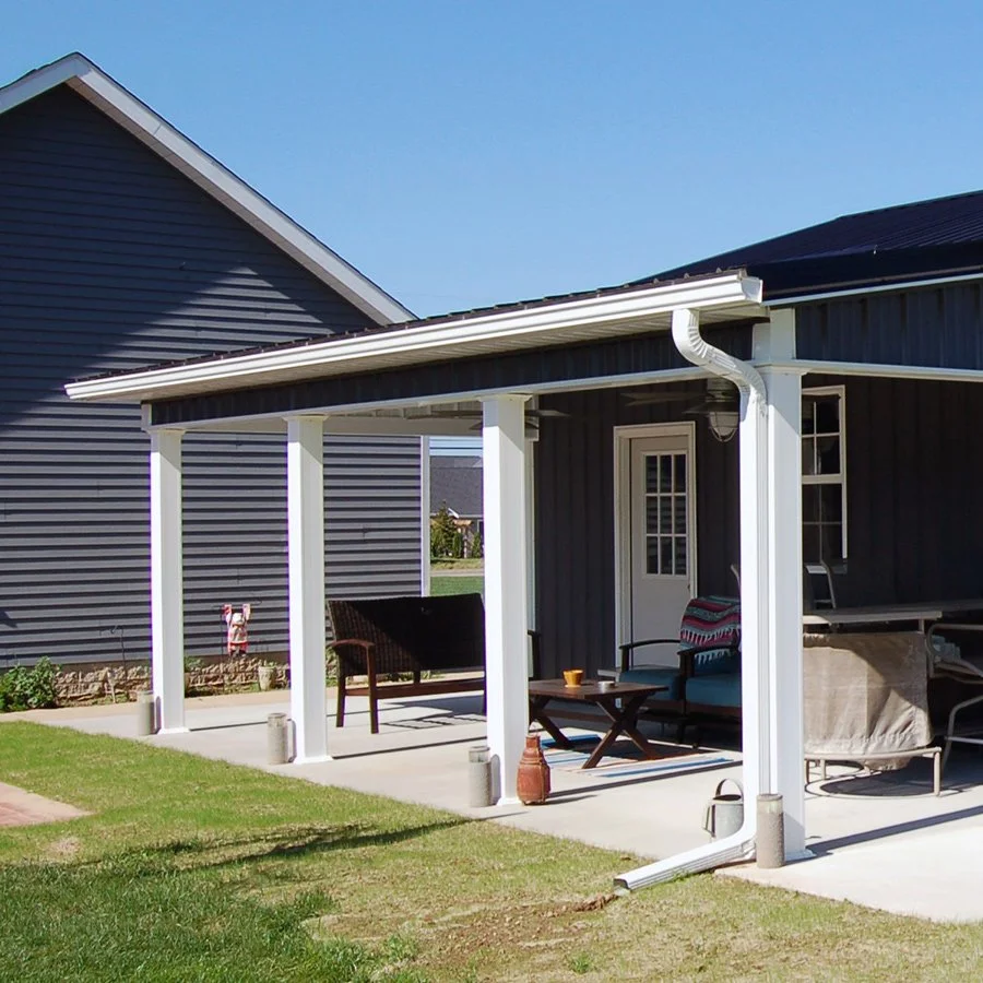 White gutters and downspouts on blue siding, illustrative image