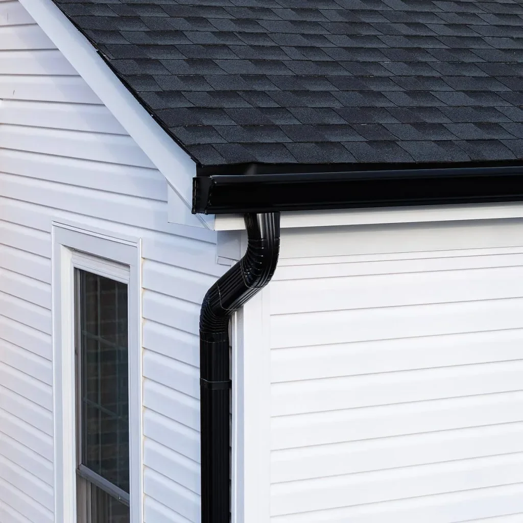 Black gutter and downspout detail, illustrative image