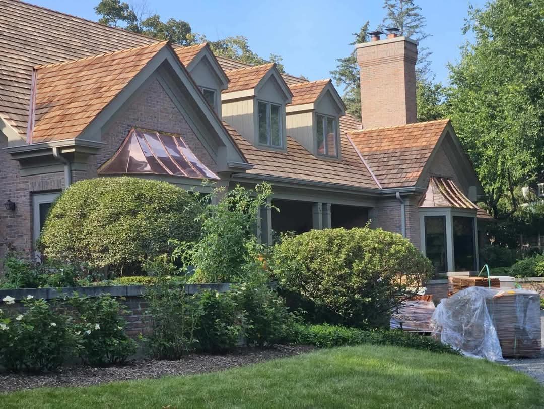 Cedar shake roofing on a steep-roofed home