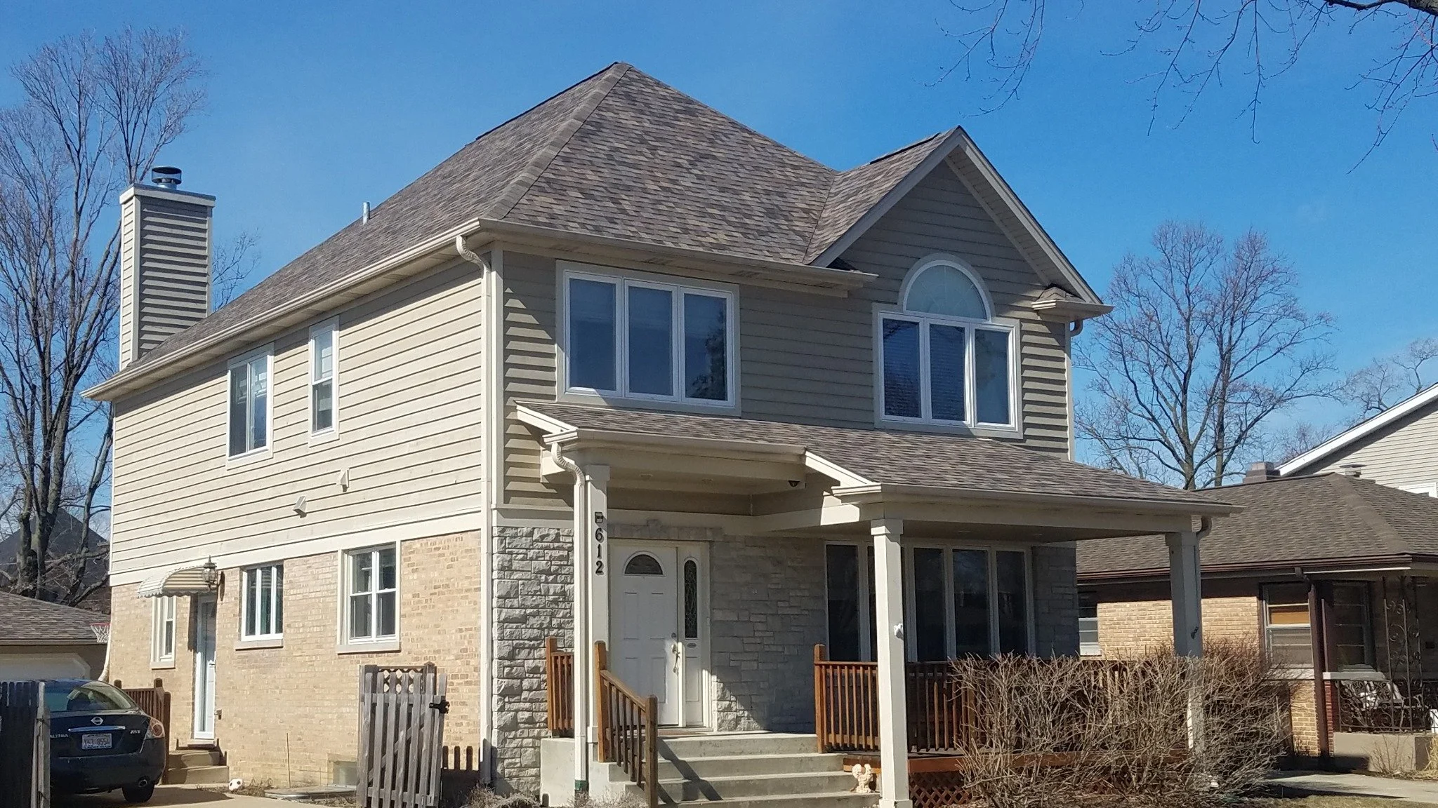 Completed home exterior with updated roof and siding