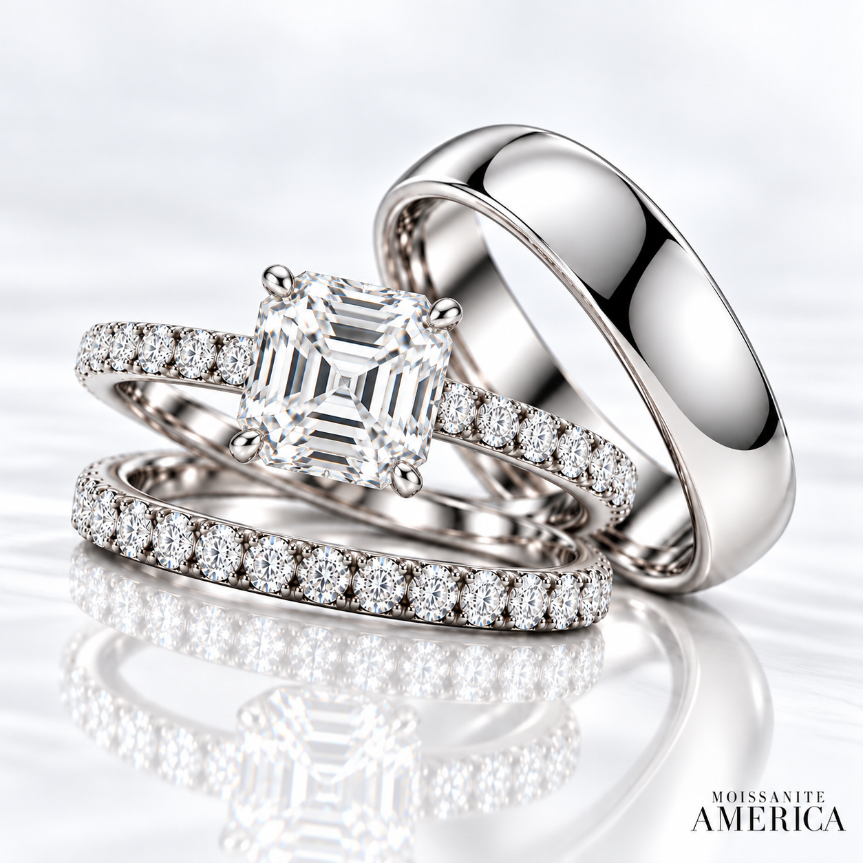 Asscher cut moissanite engagement ring on a pave band, with a matching pave wedding band and a wide white gold band for him