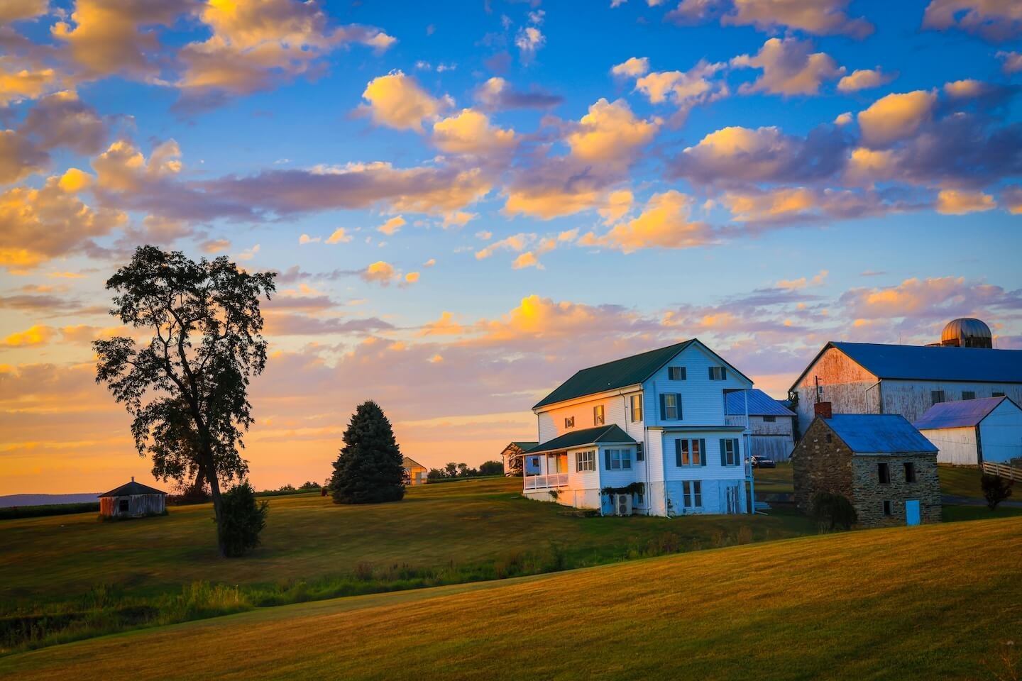 The Raw Moment: Sunset illuminating a historic Frederick County farmstead.
