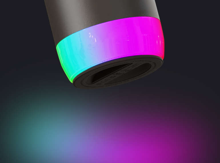 Close-up of a cylindrical device with a glowing cyan-to-magenta ring against a dark background